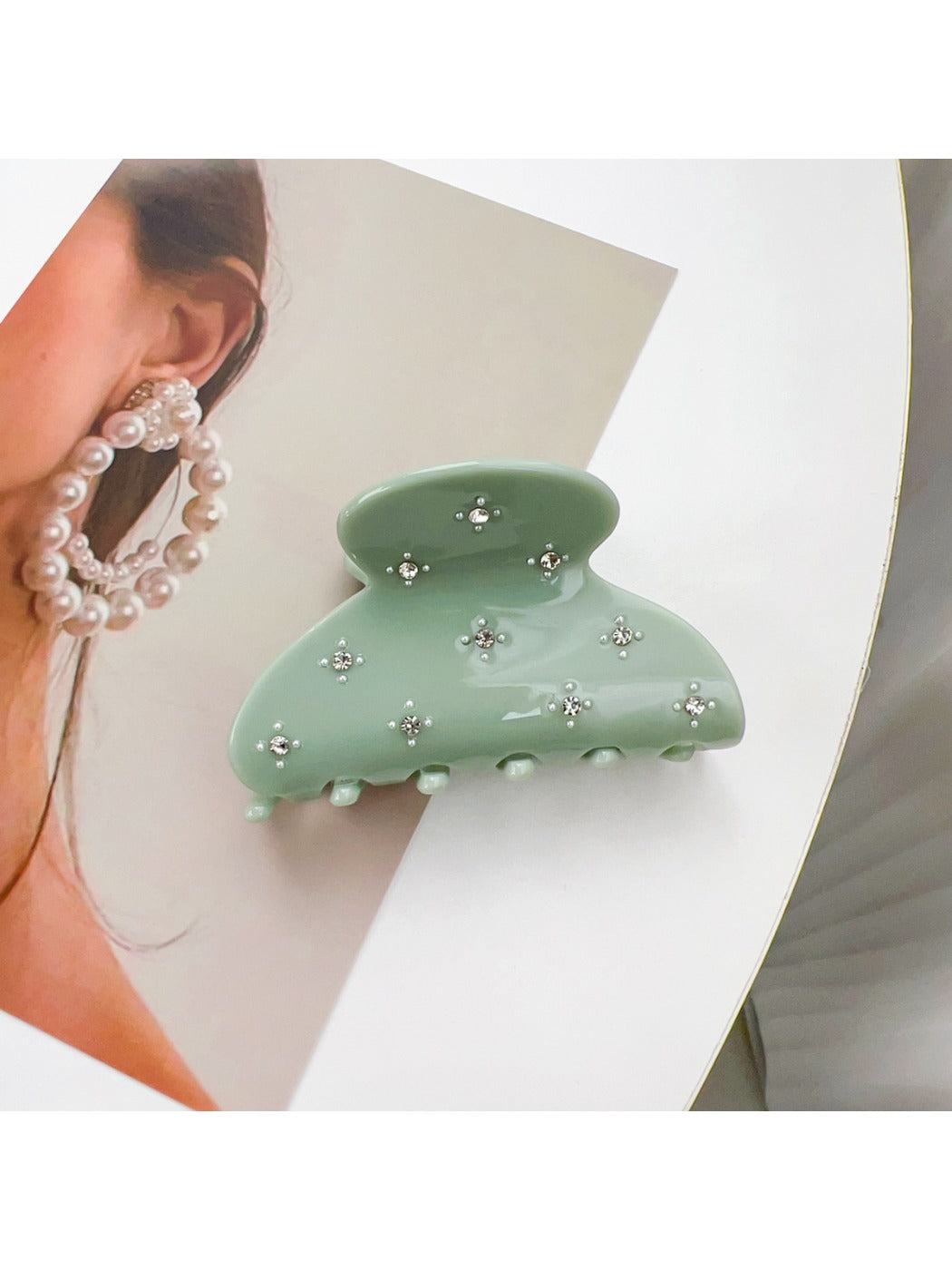 Beau hair claw clip displayed on a wooden surface with natural lighting
