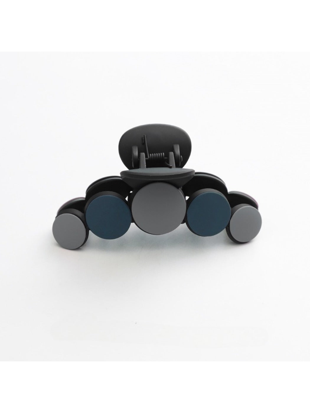 Beau hair clip resting on a wooden table with soft shadows