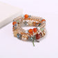 Lovra multi-row bracelet displayed with soft lighting emphasizing bead texture