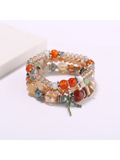 Lovra multi-row bracelet displayed with soft lighting emphasizing bead texture