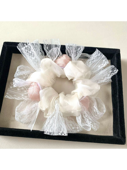 Gifty floral scrunchie styled on a wrist as a bracelet with soft fabric folds
