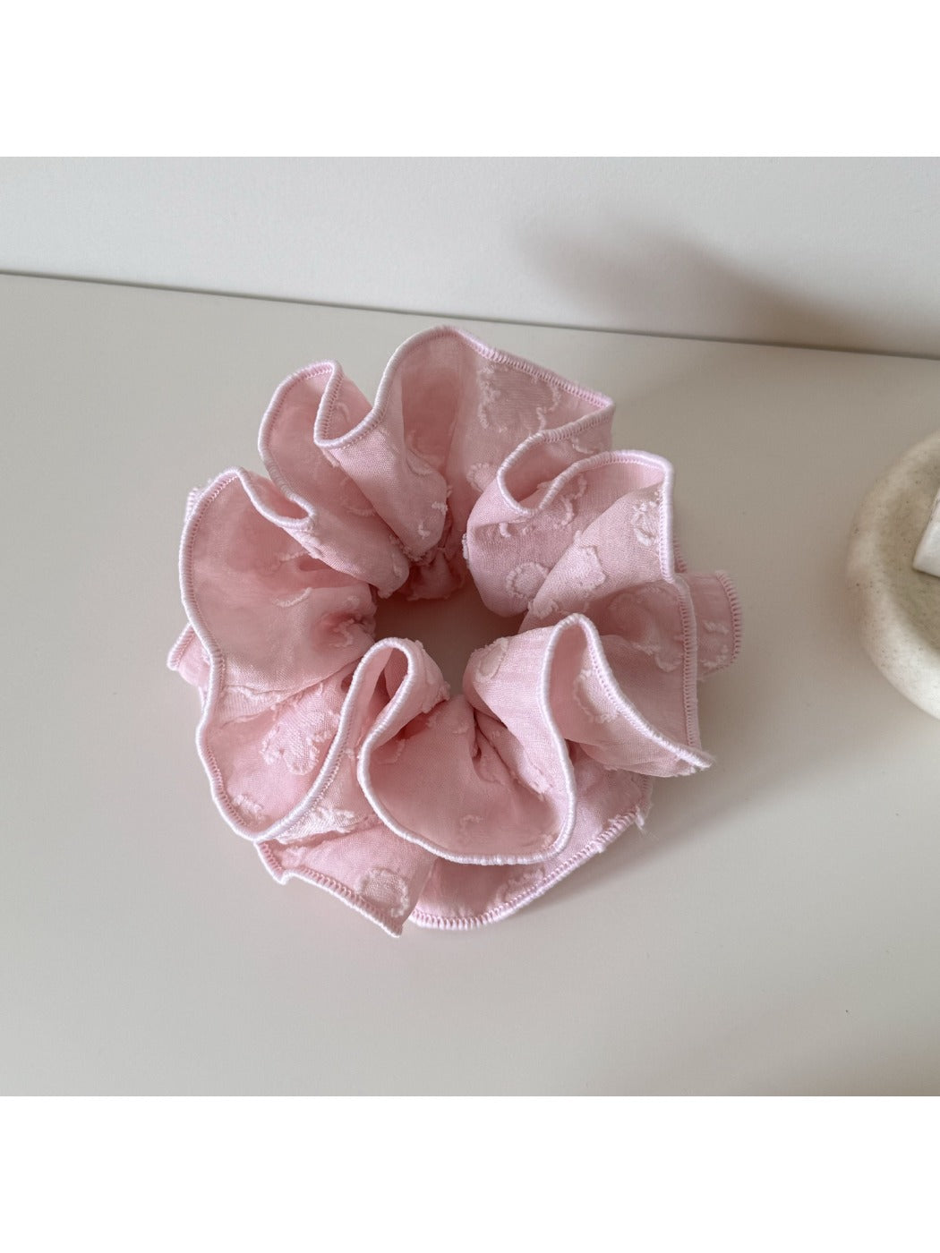 Gifty Sweet Style floral scrunchie worn on a wrist showing fabric texture and floral pattern
