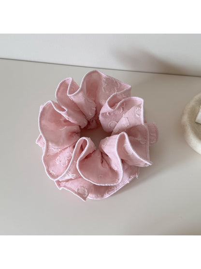 Gifty Sweet Style floral scrunchie worn on a wrist showing fabric texture and floral pattern