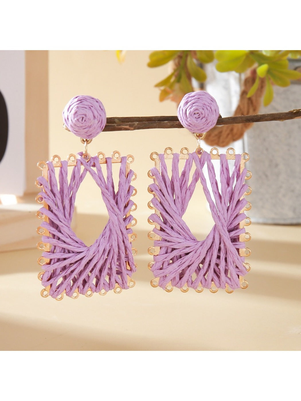 Close-up of raffia material and square shape of Earedge earrings