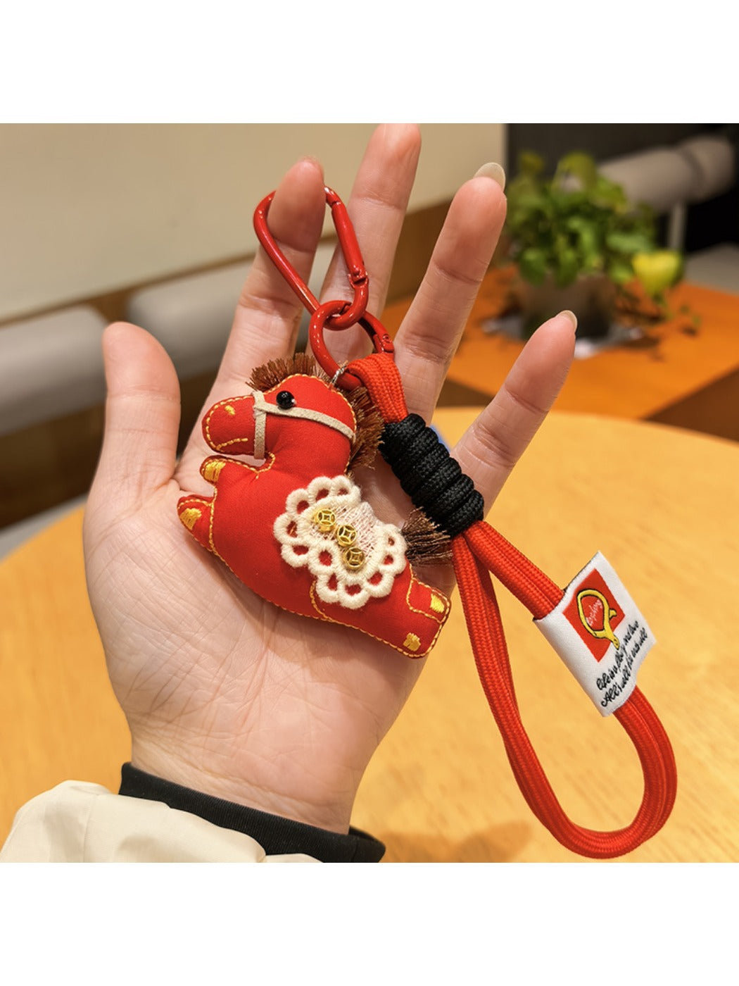 Keypus pony charm keychain with metal keyring and clasp on a colorful surface