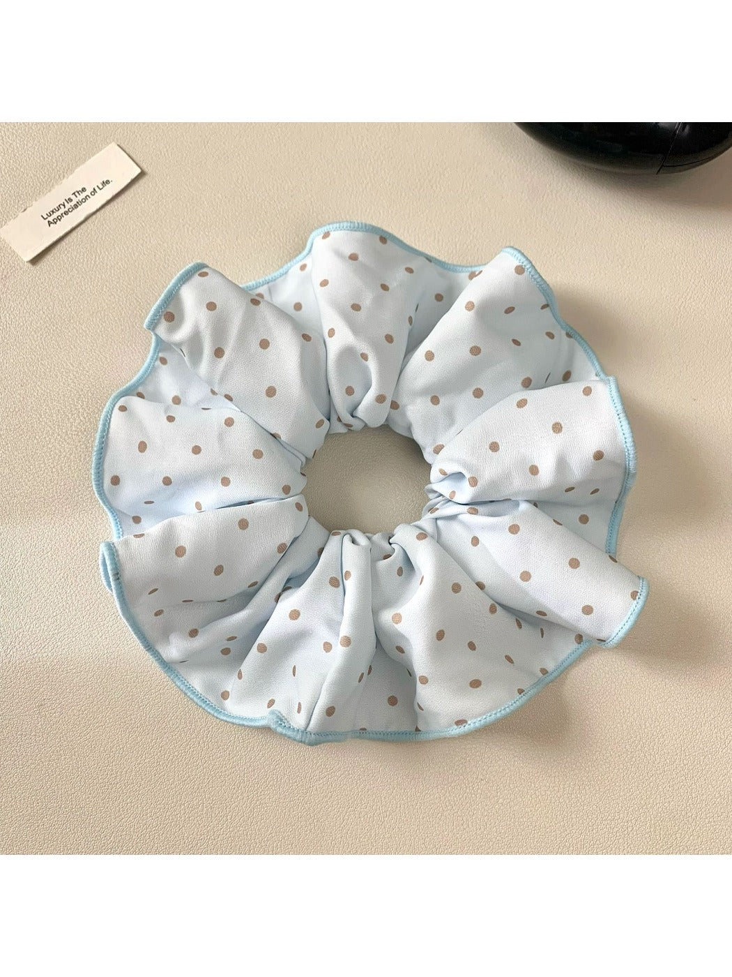 Gifty scrunchie packaged in a clear plastic bag with branding label