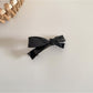 Beau hair clip styled in a half-up hairstyle on dark hair