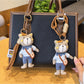 Bear charm keychain hanging from a set of keys on a wooden surface