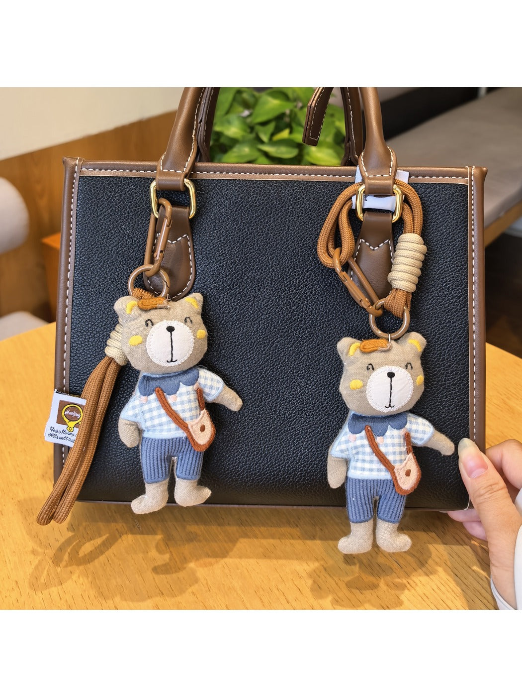 Bear charm keychain hanging from a set of keys on a wooden surface