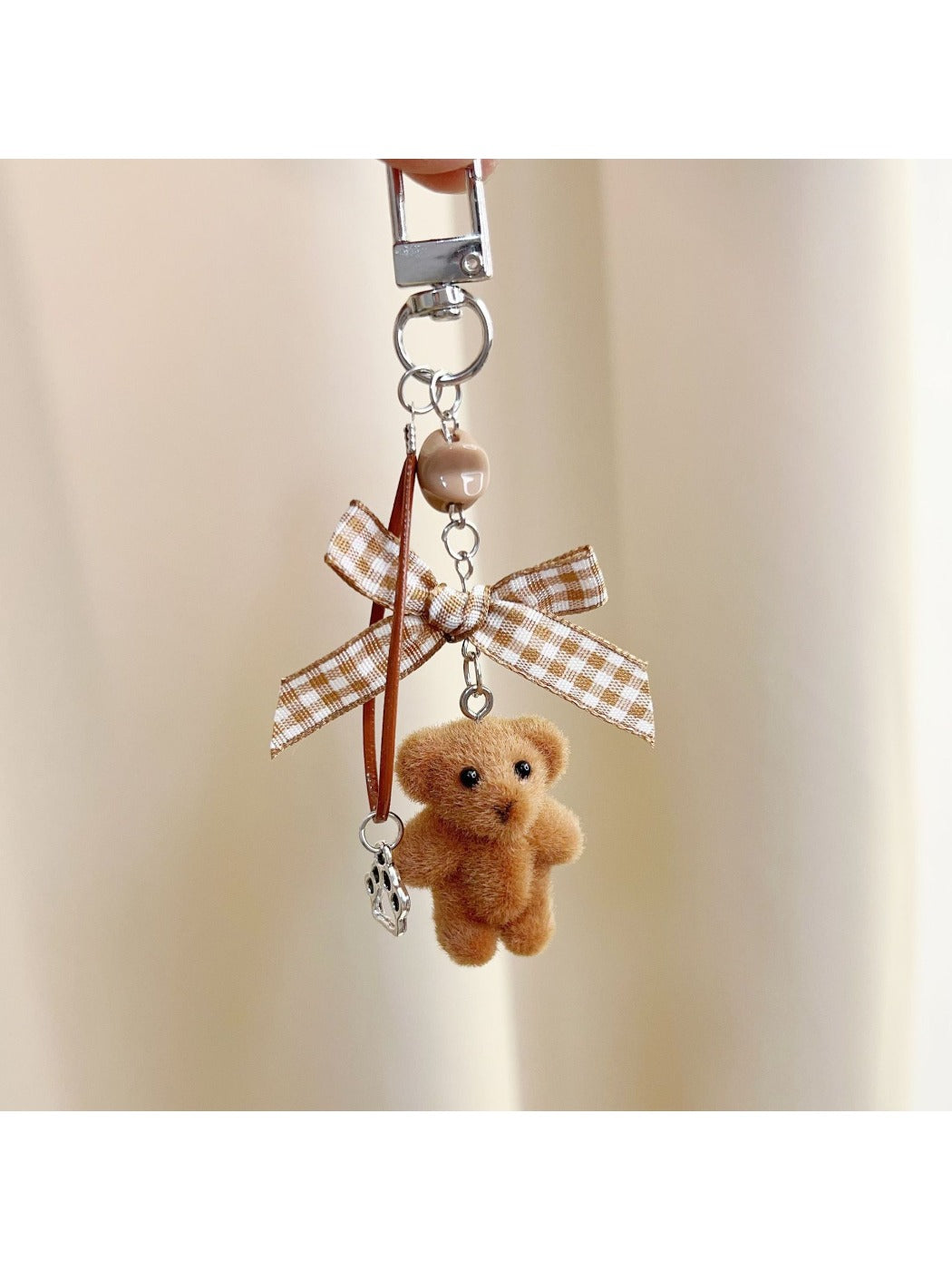 Keypus bear keychain with metal keyring and clasp on a white background