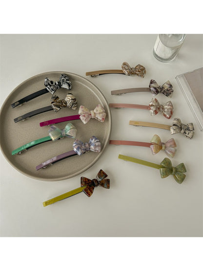 Close-up of Beau bow bar hair clip showing smooth acetate material and bow design