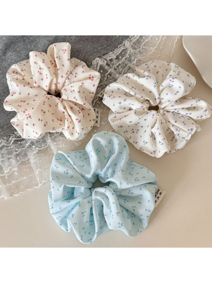 Close-up of Gifty chic tiny floral print scrunchie on a white background