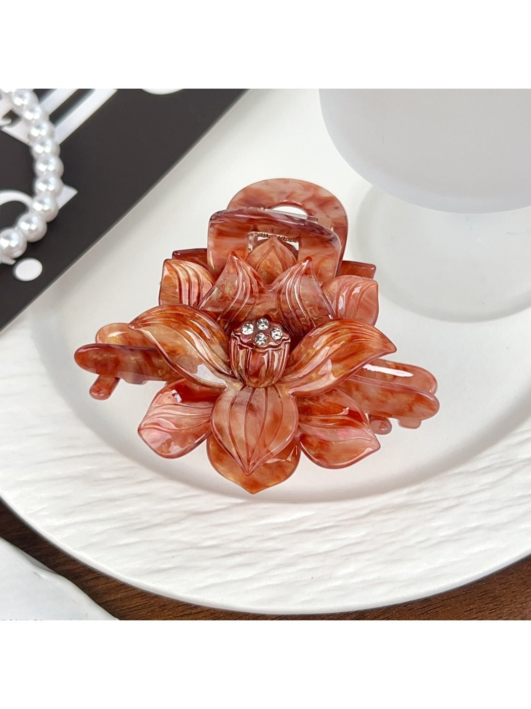 Beau lotus hair claw clip displayed with matching hair accessories
