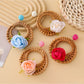 Close-up of vintage rattan woven circle earring with natural fiber texture