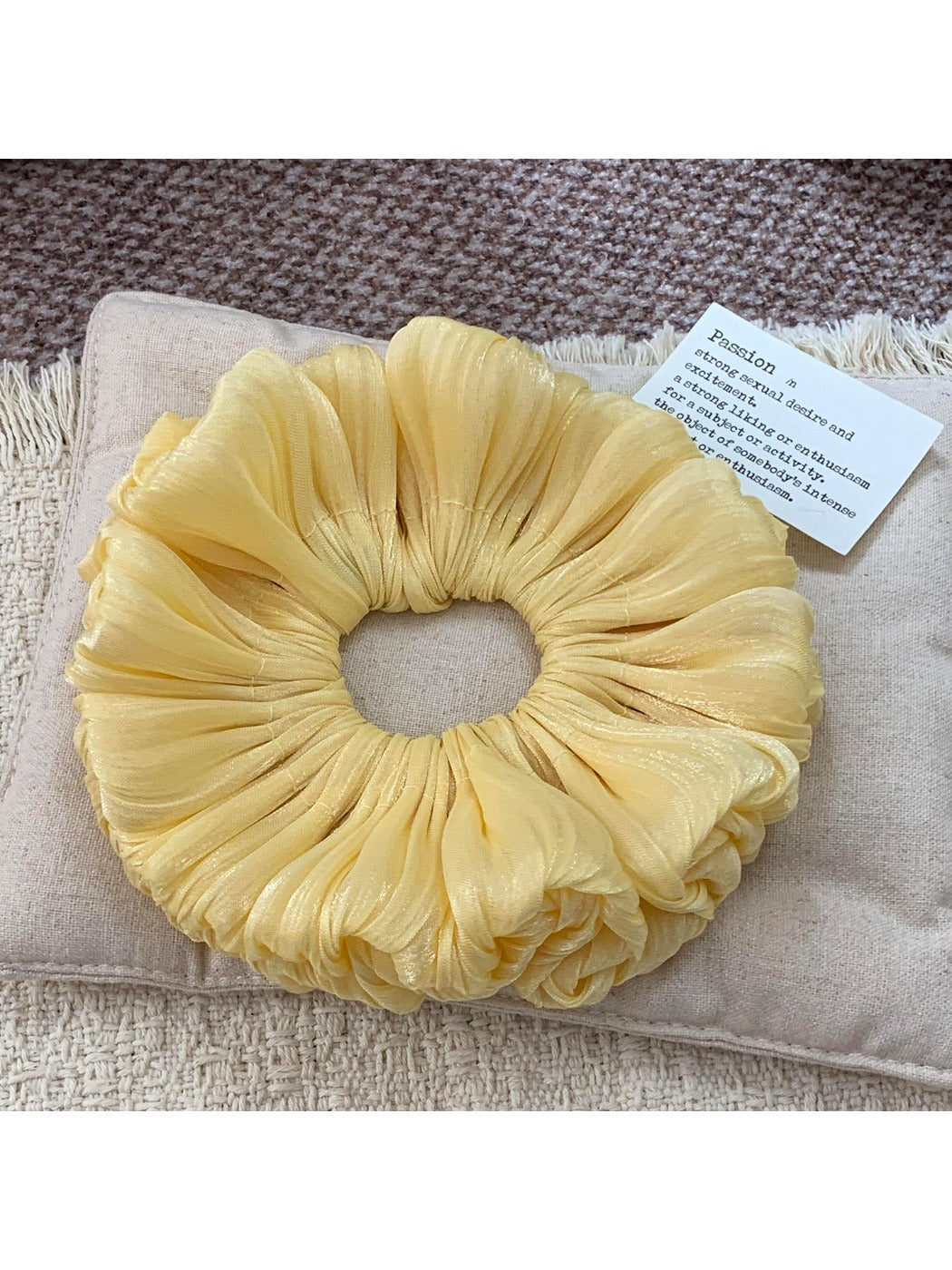 Solid color satin ruched scrunchie styled in a casual hair bun