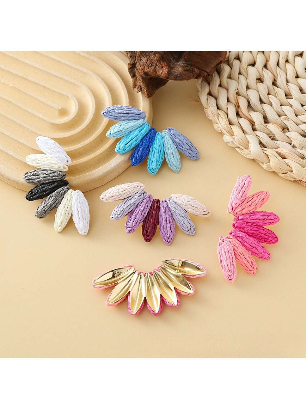 Close-up of Earedge raffia fan earrings showing woven texture and color block design