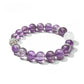Lovra vintage crystal beaded bracelet coiled on a wooden surface