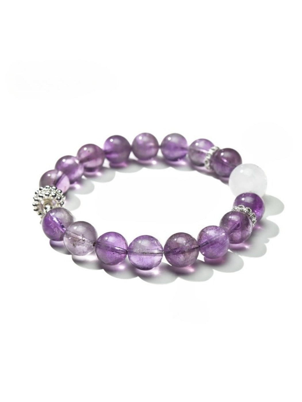 Lovra vintage crystal beaded bracelet coiled on a wooden surface