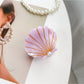 Beau shell shaped hair claw clip open to show inner teeth and hinge