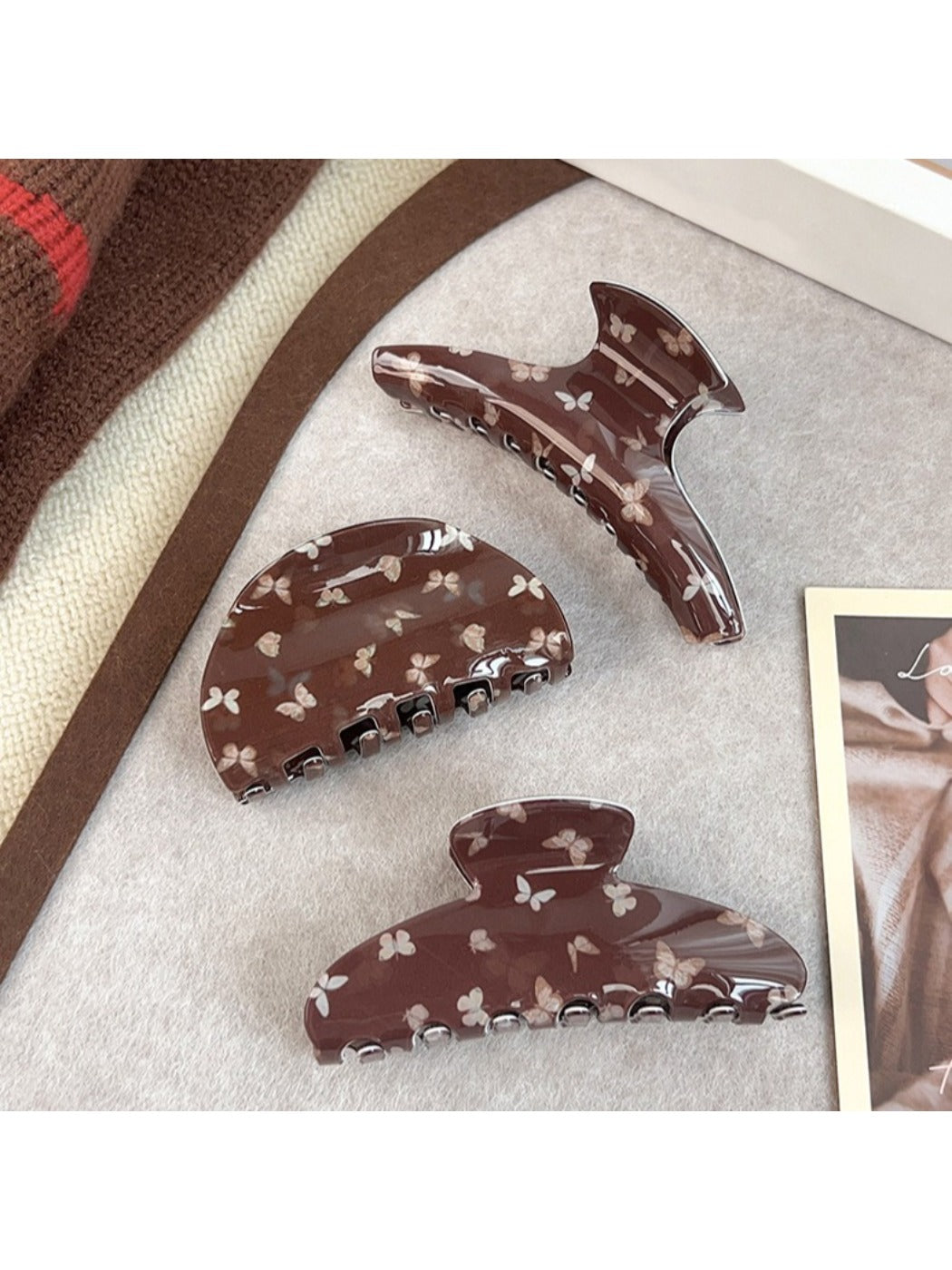 Side view of brown butterfly print claw clip highlighting clasp mechanism