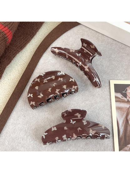 Side view of brown butterfly print claw clip highlighting clasp mechanism