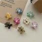 Set of rose hair ties and clips arranged neatly on a wooden surface