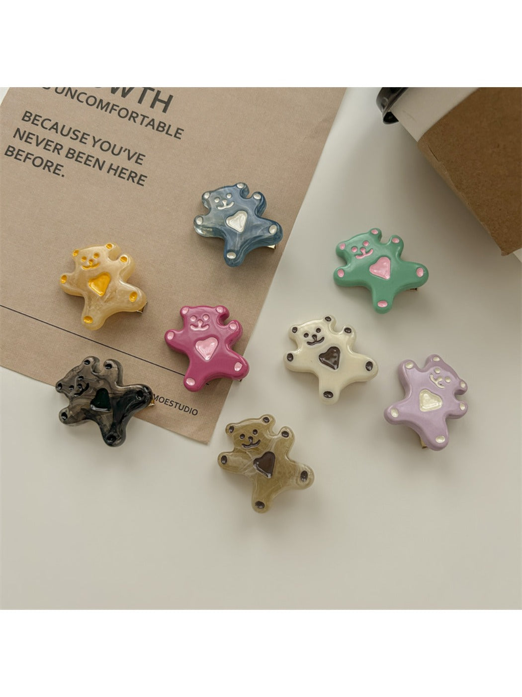 Set of rose hair ties and clips arranged neatly on a wooden surface