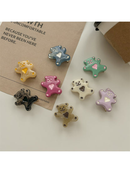 Set of rose hair ties and clips arranged neatly on a wooden surface