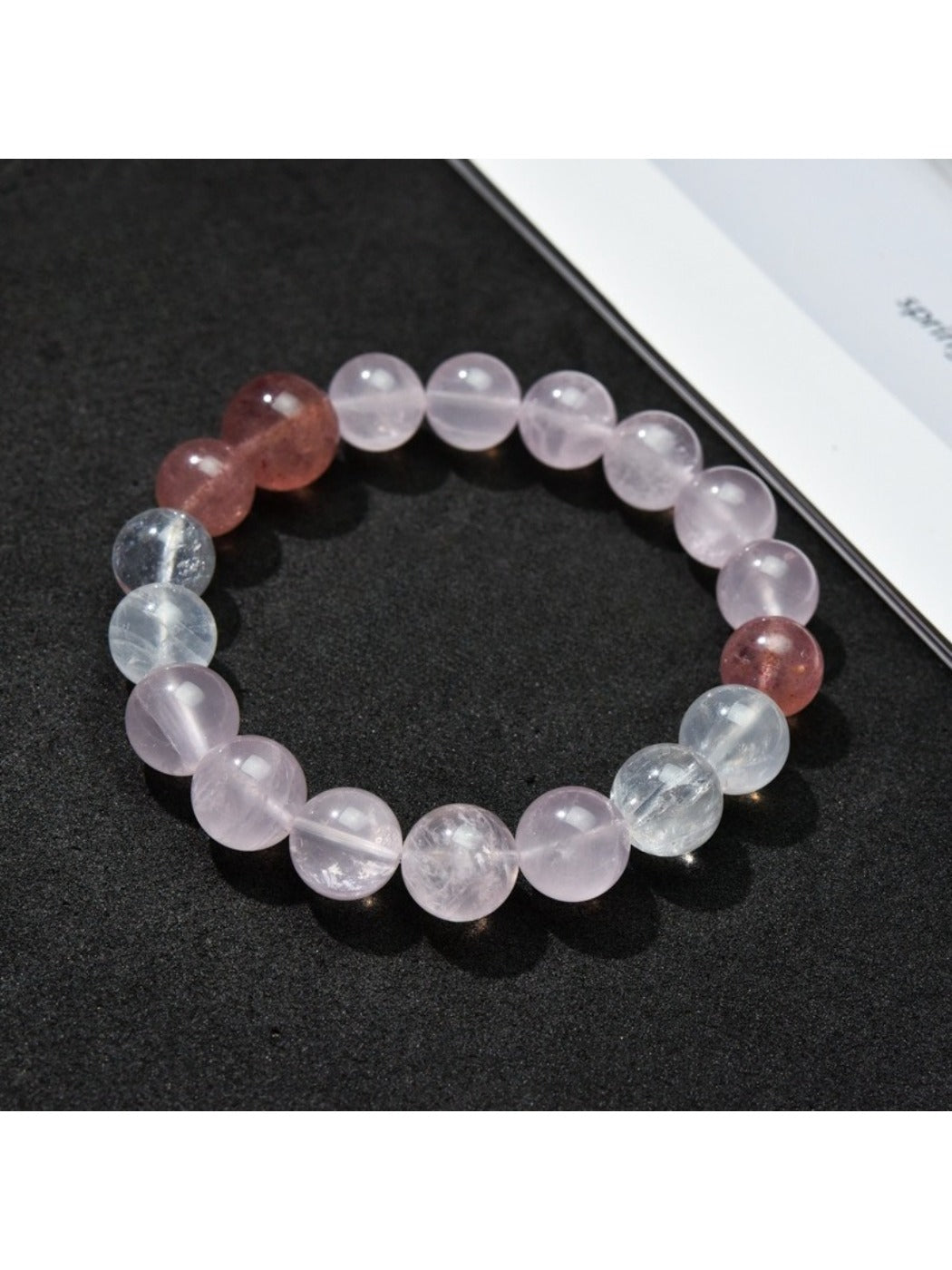 Lovra minimalist color block beaded bracelet with black, white, and beige beads on a wrist