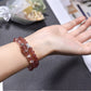 Lovra bracelet wrapped multiple times around wrist showcasing pink strawberry quartz stones