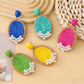 Close-up of Earedge raffia woven oval shape earrings on white background