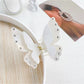 Beau butterfly claw clip resting on a wooden surface with natural light
