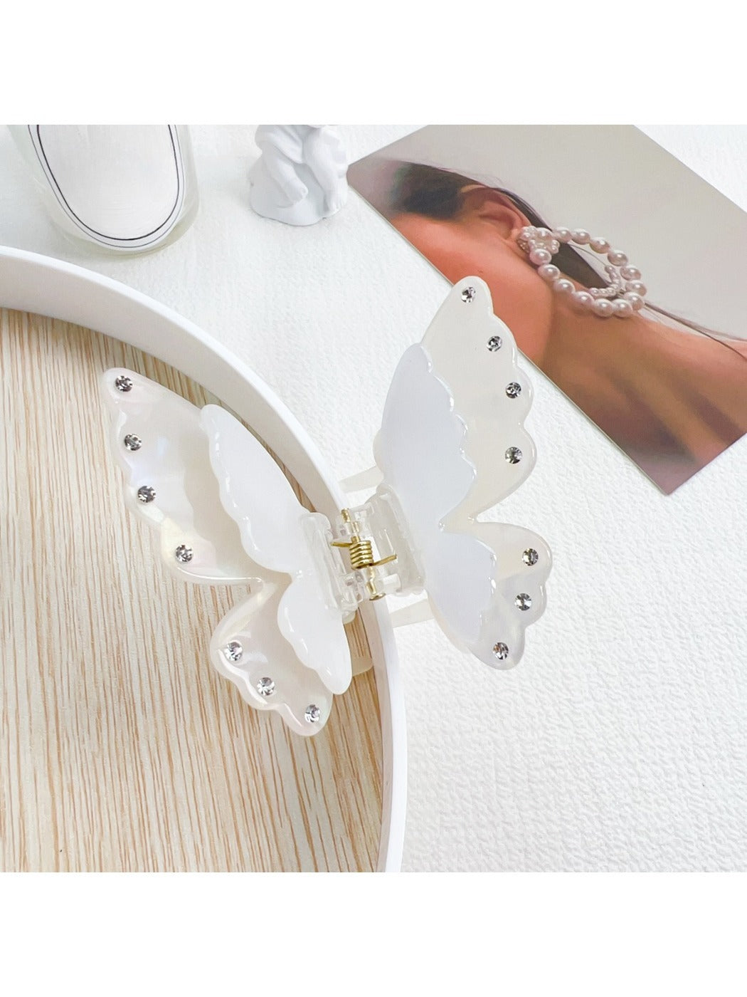 Beau butterfly claw clip resting on a wooden surface with natural light