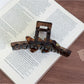 Beau large acetate claw clip displayed open showing inner teeth and clasp