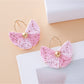 Detailed shot of raffia texture and gold hook on vintage fan shaped earrings