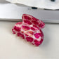 Top view of Beau pink leopard print half round claw clip showing curved shape