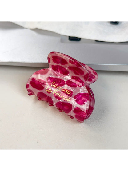 Top view of Beau pink leopard print half round claw clip showing curved shape