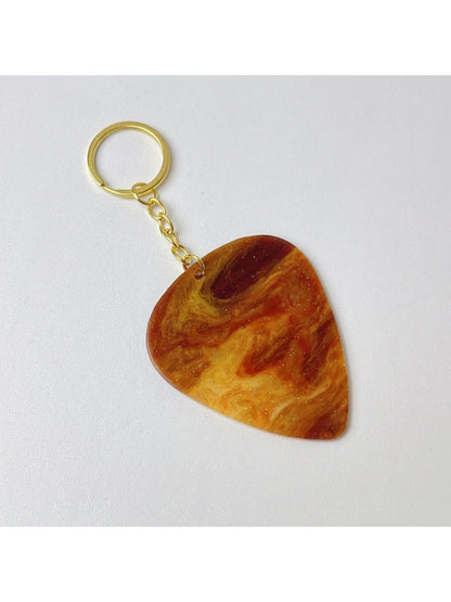 Keypus keychain with teardrop charm hanging from a backpack zipper pull