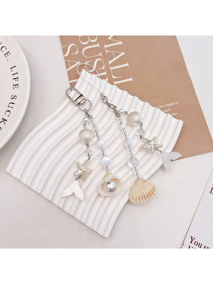 Pearlescent Keypus keychain charm hanging from a set of keys