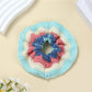Scrunchie placed on a white surface showing its soft fabric texture