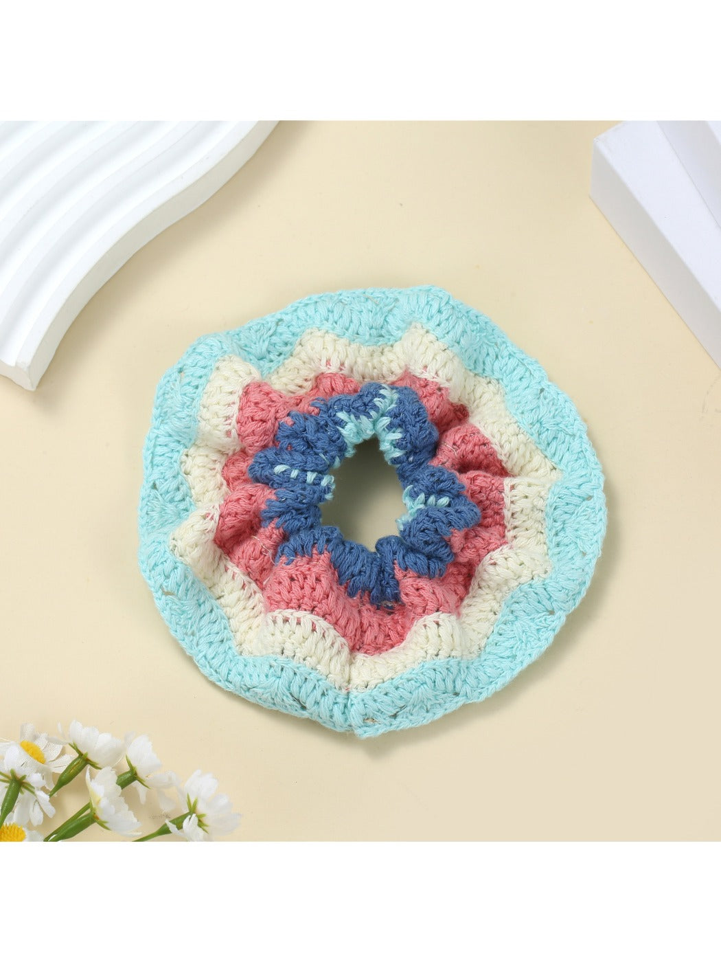 Scrunchie placed on a white surface showing its soft fabric texture