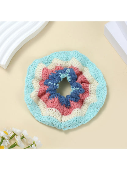 Scrunchie placed on a white surface showing its soft fabric texture