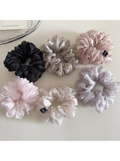 Close-up of a minimalist solid color scrunchie in soft fabric