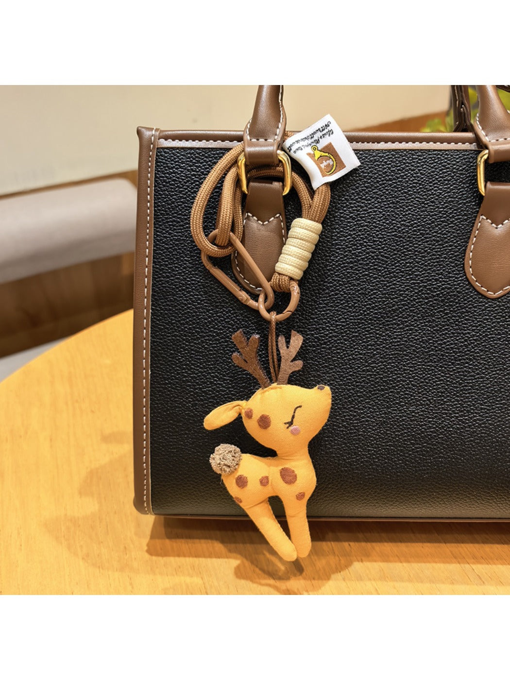 Close-up of the deer charm keychain's textured surface and polished finish