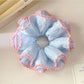 Side view of Gifty Sweet Striped Four Layer Scrunchie with layered fabric design in soft colors
