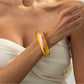 Lovra colorful bangle bracelet resting on a textured surface