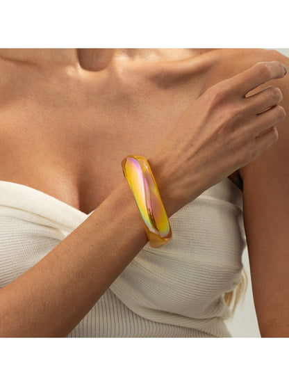 Lovra colorful bangle bracelet resting on a textured surface