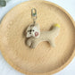 Keypus squirrel charm keychain photographed from above on a white surface