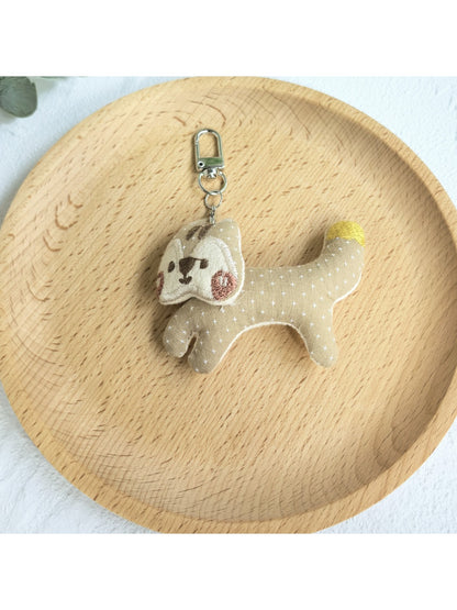 Keypus squirrel charm keychain photographed from above on a white surface