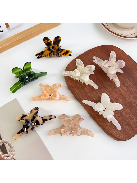 Beau minimalist hair claw clip with a delicate bow detail in neutral color